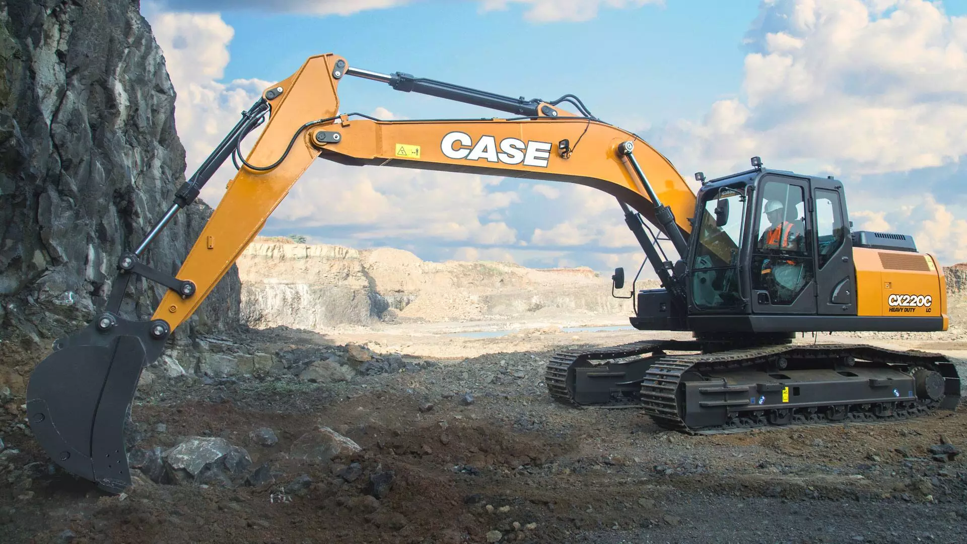 Tracked loader moving dirt pile